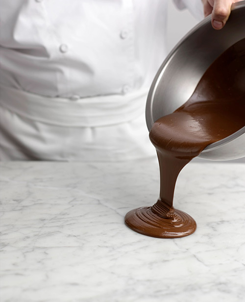 Pouring gianduja on a marble surface