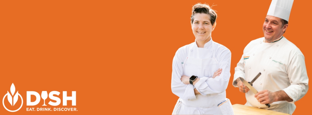 Two chefs from The Culinary Institute of America working together in a professional kitchen, preparing a dish with focused expressions.