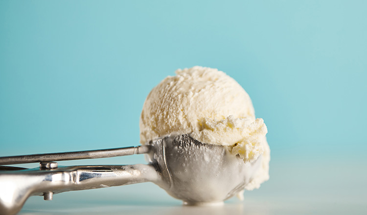 Vanilla ice cream in a metal scoop